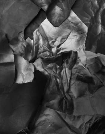background of fragments of crumpled paper, black and white