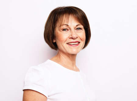 Portrait of senior woman with cute smile over white background
