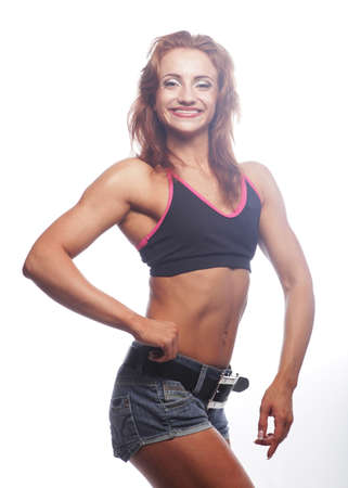 Photo of cheerful young woman dressed sportwear over white background.の写真素材