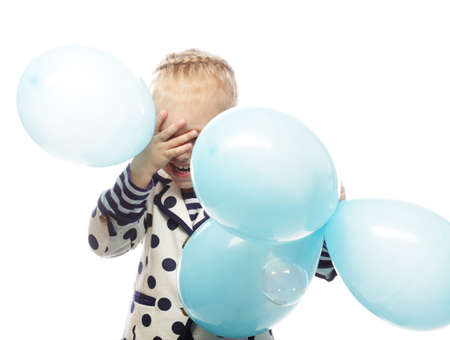 Happy little girl child with a blue balloons on white backgroundの写真素材