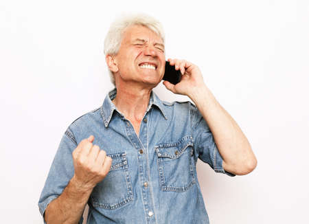 Photo of crazy ecstatic old man use smartphone impressed social media like feedback win raise fists...