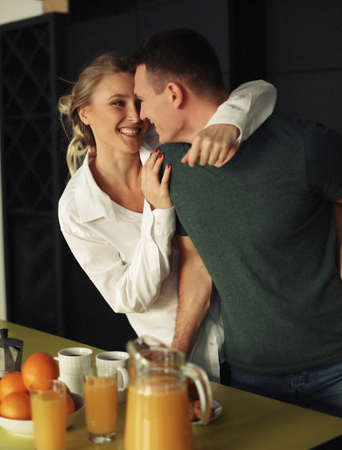 Young happy lovely couple have breakfast in the early morning at home