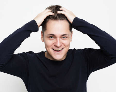 Close-up portrait of handsome adult man with beaming smile, looking camera satisfied, feel upbeat...