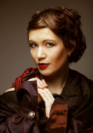 Portrait of young woman with retro hairstyle and stylish scarf