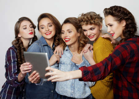 hipster female friends taking selfie with digital tabletの写真素材