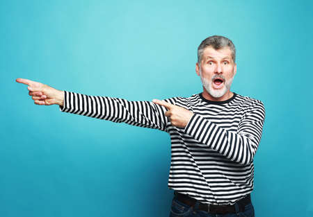 Lifestyle, emotion and old people concept - handsome senior bearded surprised man wearing striped...