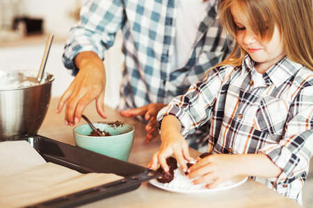 Mom with her 4 years old daughter are cooking in the kitchen to Mothers day, Family creativity, hobbies, joint activities with children.の写真素材