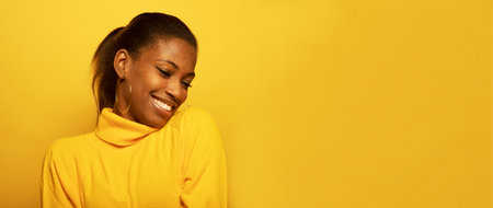 Lifestyle, emotion and people concept: Portarit of good-looking carefree and relaxed young beautiful african-american young woman smiling broadly over yellow backgroundの写真素材