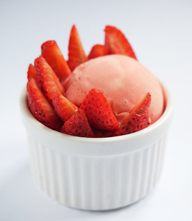 Strawberry ice cream and fresh strawberry berries, delicious dessert over gray backgroundの写真素材