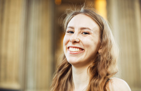 Close up Cheerful Blond Young Woman at the Street, Looking at the Camera with Toothy Smile.の写真素材