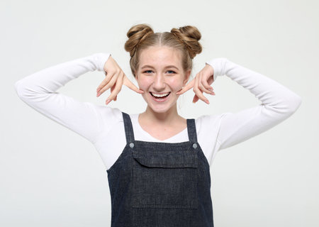 lifestyle, fashion and people concept: beautiful happy blond woman wearing casual clothes, posing on white backgroundの写真素材