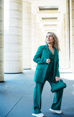 Full length fashionable woman walking Street city and wears trendy casual clothes outfitの写真素材