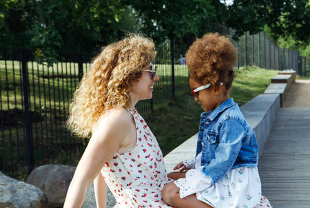 Happy, mother and girl laughing in park relaxing or smiling in nature on holiday vacation as a family. Lifestyle concept.の写真素材