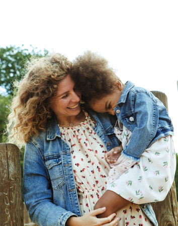 Mother and daughter hugging outside. Lifestyle and people concept.の写真素材