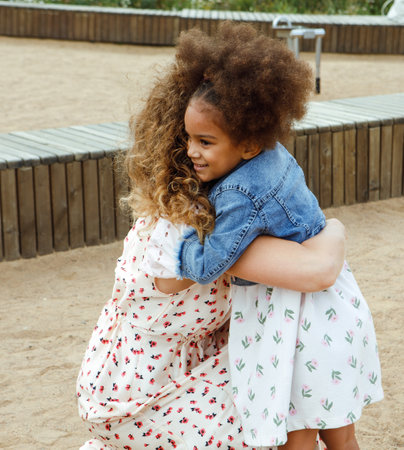 Mother and daughter hugging outside. Lifestyle and people concept.の写真素材