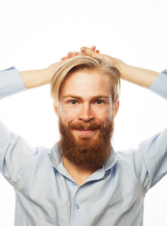 handsome ginger hipster man with beard looking at camera over white backgroundの写真素材