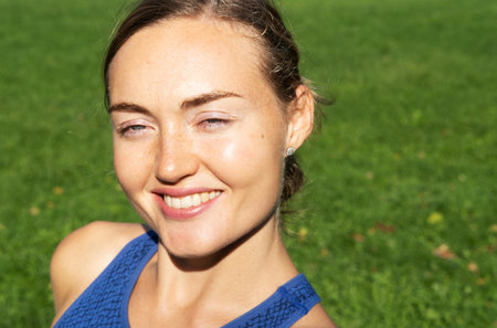 Portrait of a young athletic woman in the morning park before training.