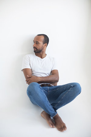 Photo of young afro man wear white t-shirt isolated on gray backgroundの写真素材