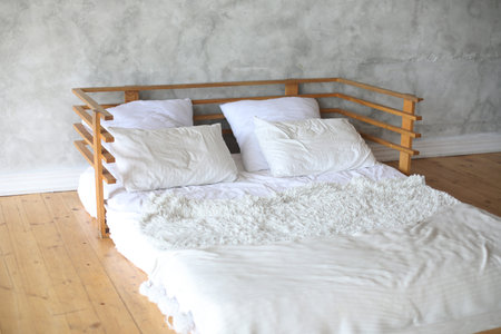 Interior of light room with big bed, white and cleanの写真素材