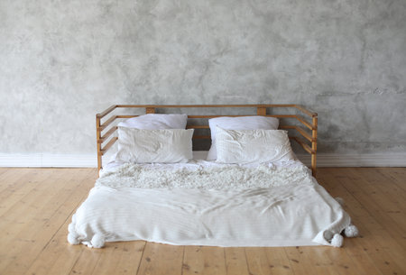 Interior of light room with big bed, white and cleanの写真素材