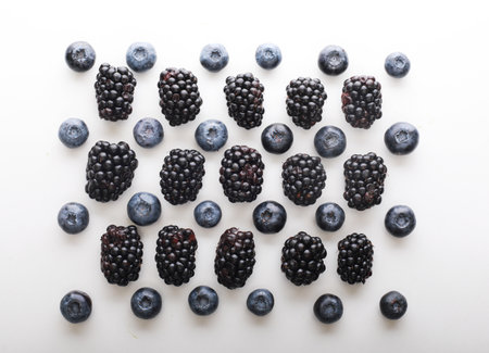 Mix berries patern over white background. Blackberries and blueberries. Close up.の写真素材
