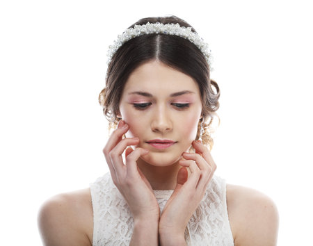 Fashionable bride with gorgeous diadem. Studio portrait young female model over white background.の写真素材