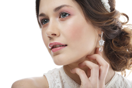 Fashionable bride with gorgeous diadem. Studio portrait young female model over white background.の写真素材