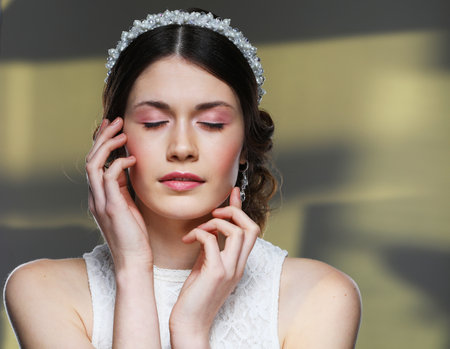 Beautiful Bride Portrait wedding makeup hairstyle, gorgeous young woman with closed eyes in white dress. Close up picture.の写真素材