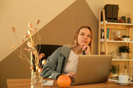 Young blond woman dressed casual working laptop. Business woman busy working on laptop computer at office.の写真素材