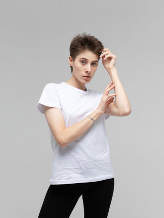 lifestyle, fashion and people concept: young woman with dark short hair posing in studio.の写真素材