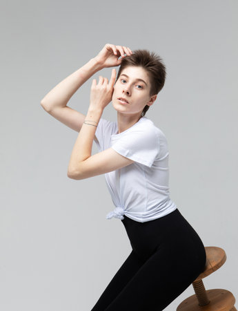 lifestyle, fashion and people concept: young fashion woman model with dark short hair posing in studio.の写真素材