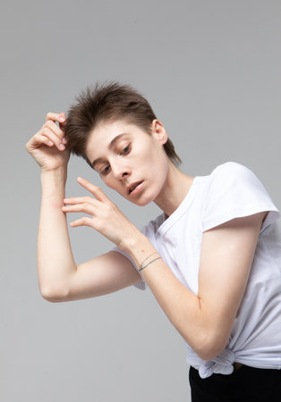lifestyle, fashion and people concept: young woman with dark short hair posing in studio.の写真素材