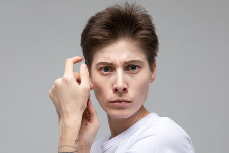 lifestyle, people concept: young woman with dark short hair posing in studio.の写真素材