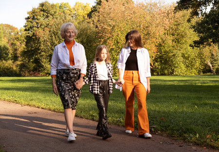 Lifestyle and people concept. Grandmother With Granddaughter And Mother In Autumn Park. Happy family.の写真素材