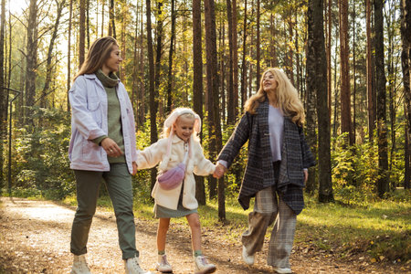 Lifestyle and people concept. Grandmother With Granddaughter And Mother In Autumn Park. Happy family.の写真素材