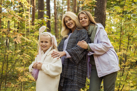 Lifestyle and people concept. Grandmother With Granddaughter And Mother In Autumn Park. Happy family.の写真素材