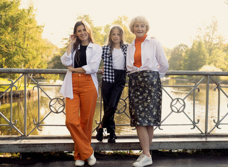 Lifestyle and people concept. Grandmother With Granddaughter And Mother In Autumn Park. Happy family.の写真素材
