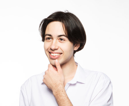 Portrait of a handsome man smiling against white background. Close up picture.の写真素材
