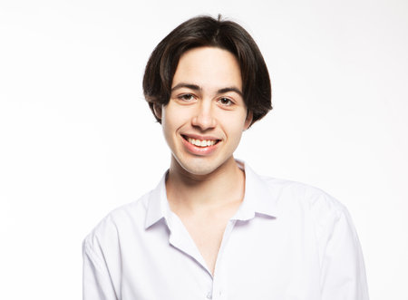 Portrait of a handsome man smiling against white background. Close up picture.の写真素材