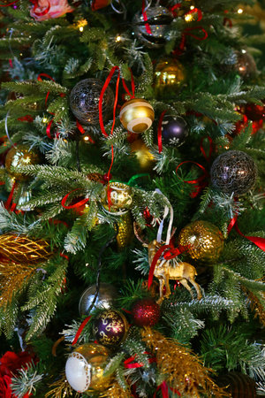 New year or Christmas interior at home. Stylish Christmas tree with red and gold decorations. Holiday concept.の写真素材