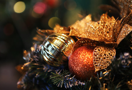 Festively Decorated Outdoor Christmas tree with bright red balls on blurred sparkling fairy background.の写真素材