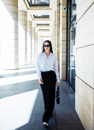Young fashionable woman next to modern business center.の写真素材
