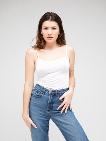 fashion model posing in studio over gray backgroundの写真素材