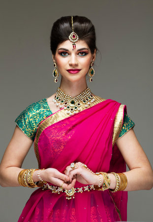 Young attractive model dressed in posh, gildet, Indian costume. Traditional Indian costume. Charming of classic national Indian style.の写真素材