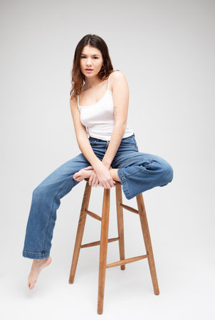 fashion model posing on chairの写真素材