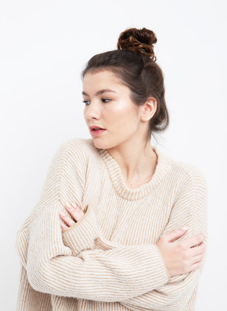 lifestyle, fashion and people concept: beautiful woman wearing casual beige sweaterの写真素材