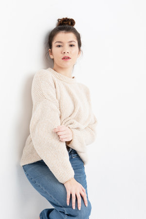 lifestyle, fashion and people concept: beautiful woman wearing casual beige sweaterの写真素材