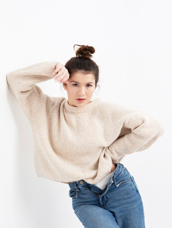 lifestyle, fashion and people concept: beautiful woman wearing casual beige sweaterの写真素材