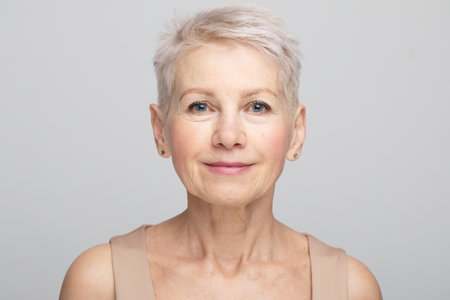 Beauty portrait of mature woman over gray background.の写真素材