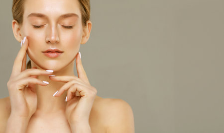 Beauty Woman face Portrait with closed eyes. Beautiful Spa model Female with Perfect Fresh Clean Skin. Gray background.の写真素材